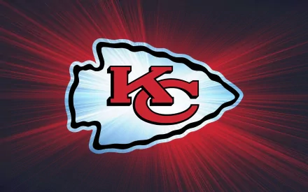 Kansas City Chiefs logo set against a dynamic red and blue background, designed as a high-definition desktop wallpaper showcasing team spirit in sports.