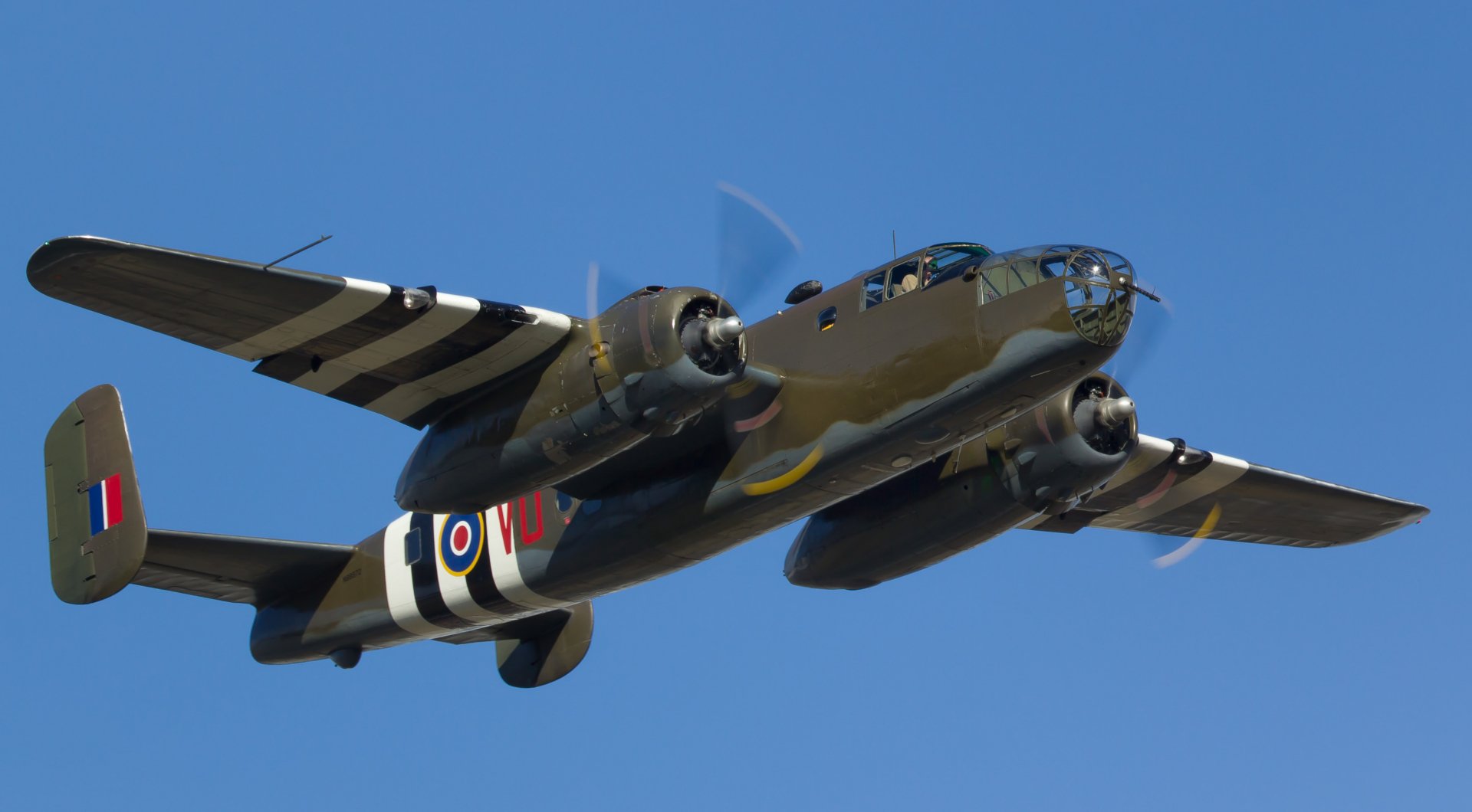 HD PC desktop wallpaper featuring a military aircraft flying against a clear blue sky.