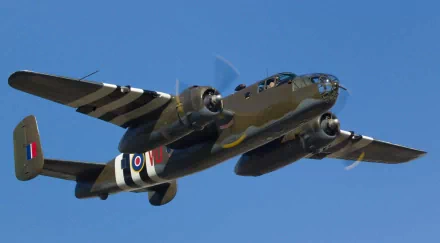 HD PC desktop wallpaper featuring a military aircraft flying against a clear blue sky.
