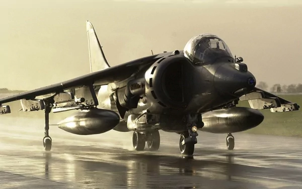 4K Ultra HD military-themed desktop wallpaper featuring a Harrier Jump Jet taxiing on a wet runway with muted, atmospheric lighting.