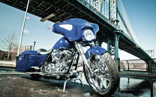 A striking blue Harley-Davidson motorcycle is showcased in this 4K Ultra HD wallpaper, set against the backdrop of an impressive bridge. Bright chrome detailing adds to its allure.