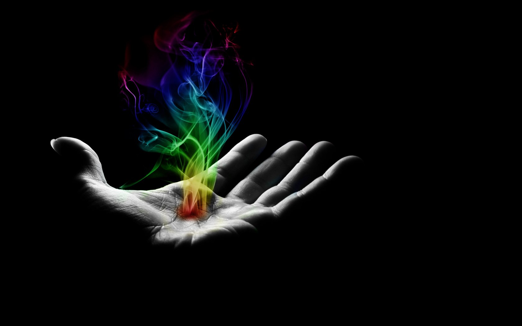 A captivating HD desktop wallpaper featuring a hand emanating colorful smoke and fire against a dark background, showcasing an artistic blend of light and shadow.