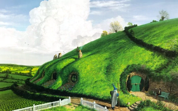 HD fantasy wallpaper of The Lord of the Rings’ Comarca, showcasing lush green hills with hobbit holes and a character standing near a round green door.