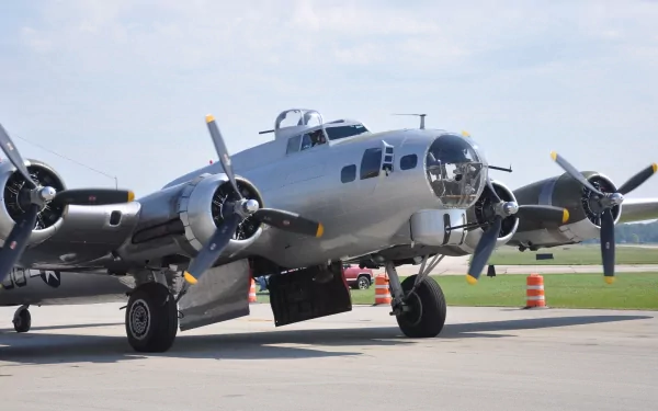 Boeing B-17 Flying Fortress military bomber on a sunny tarmac, close-up of nose and propellers; 4K Ultra HD PC desktop wallpaper and background.