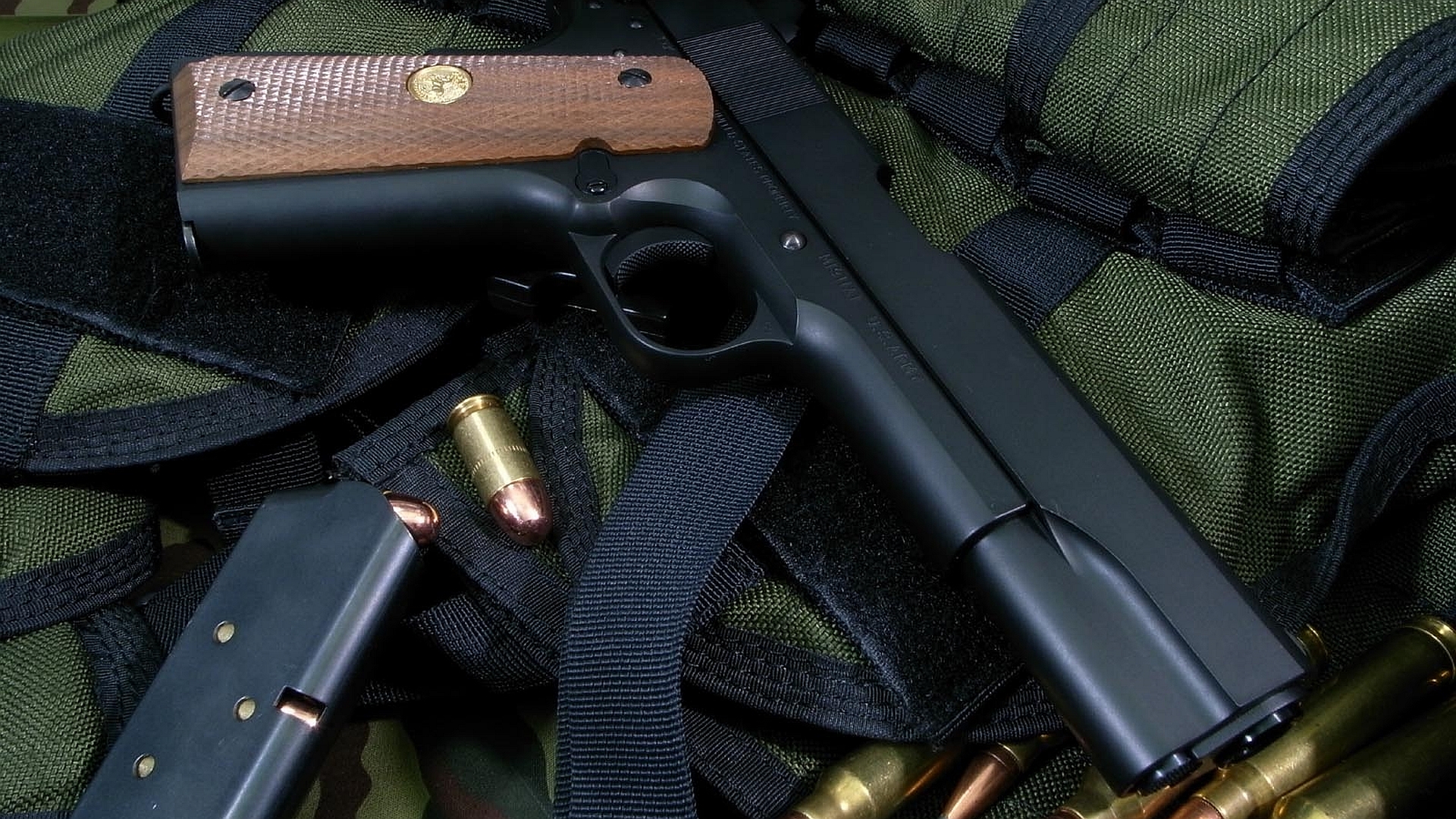 A sleek pistol rests on a dark background, perfect for a Man Made desktop wallpaper.