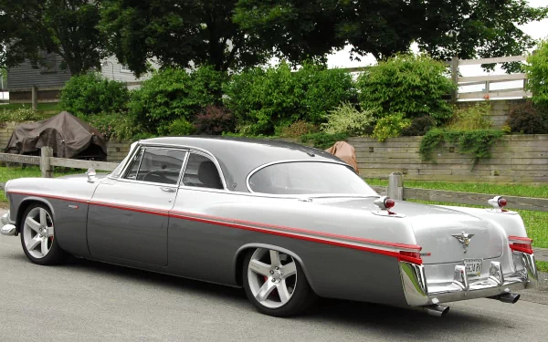 HD PC desktop wallpaper background — classic gray Chrysler vehicle coupe with red stripe, rear three-quarter view parked on a tree-lined suburban street.