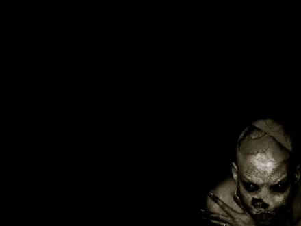 A dark, scary HD wallpaper featuring a sinister figure emerging ominously from the shadows on a black background.