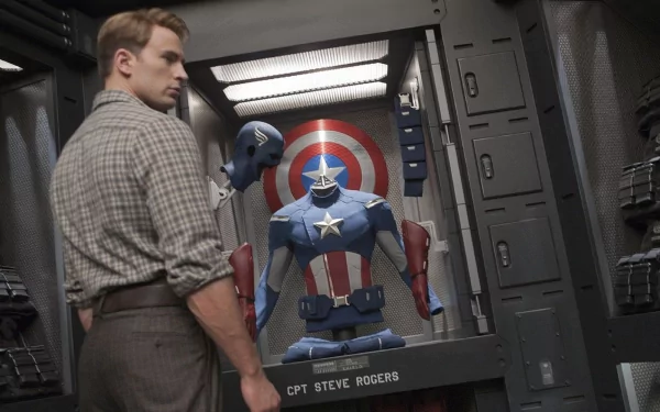 A high-definition wallpaper featuring Chris Evans as Captain America, standing before a display case with his iconic suit and shield from the Avengers movie series.