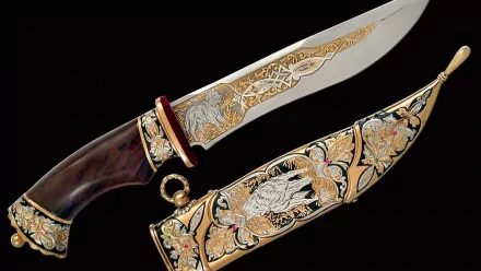A stunning HD desktop wallpaper featuring an intricately designed man-made knife with a beautifully engraved blade and ornate sheath, set against a dark background.