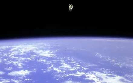 An astronaut floats in space above Earth, showcasing a stunning view of the planet. This HD image captures the beauty of our world, highlighting NASA's achievements in space exploration.