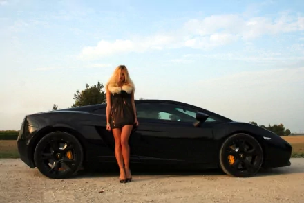 A woman with long blonde hair stands confidently next to a sleek black sports car, set against a picturesque sky, creating an appealing HD desktop wallpaper background.
