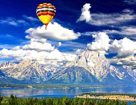 4K Ultra HD PC desktop wallpaper: a colorful hot air balloon vehicle floats over a tranquil lake with towering snow-capped mountains beneath dramatic cloud-filled skies.
