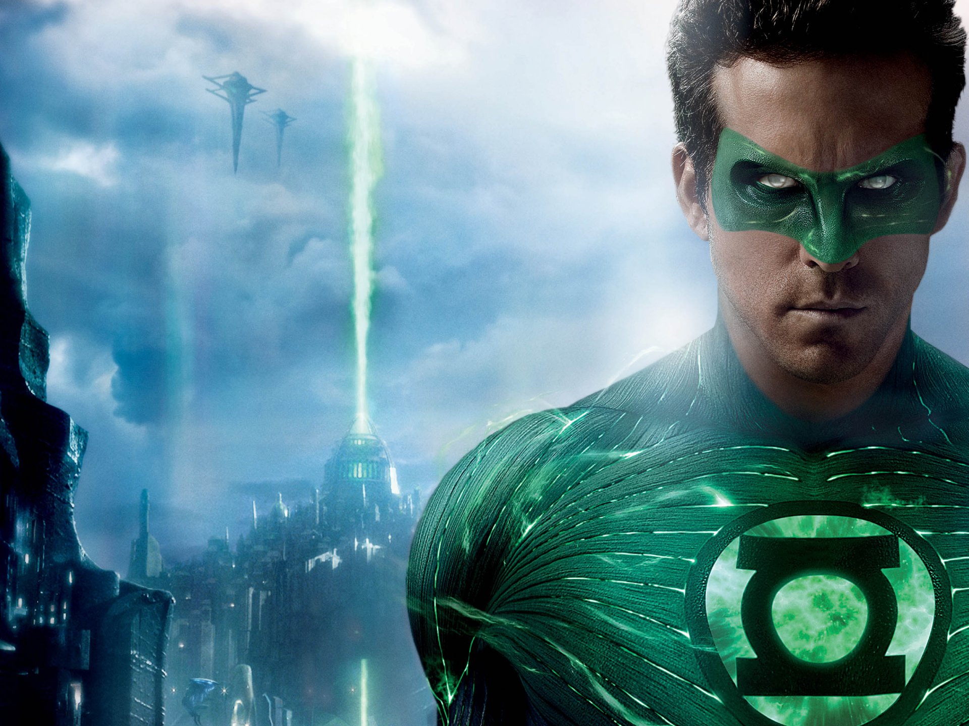 HD desktop wallpaper featuring Ryan Reynolds as Green Lantern with a glowing green suit and cityscape background under a cloudy sky.