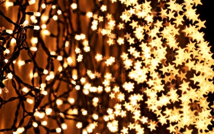 A close-up of twinkling Christmas lights, featuring star-shaped decorations, creating a festive holiday atmosphere. This high-definition image makes a vibrant desktop wallpaper or background.
