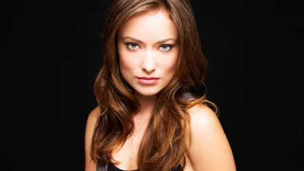 HD desktop wallpaper featuring a close-up portrait of celebrity Olivia Wilde against a black background.
