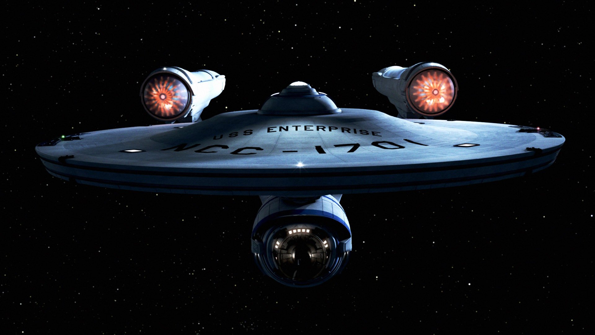 Sci‑Fi Star Trek HD PC desktop wallpaper: front view of the USS Enterprise NCC‑1701 gliding through a starfield, glowing warp nacelles and saucer section illuminated.