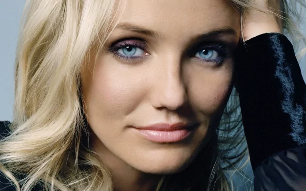 Close-up HD desktop wallpaper of celebrity Cameron Diaz with blonde hair and blue eyes, wearing a dark garment against a neutral background.
