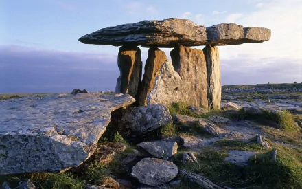 HD PC desktop wallpaper showcasing a scenic nature view of an ancient stone dolmen structure under a soft, cloudy sky.