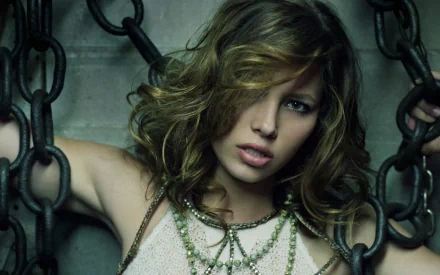 HD desktop wallpaper and background featuring celebrity Jessica Biel, posing with a captivating expression amidst a backdrop of chains.