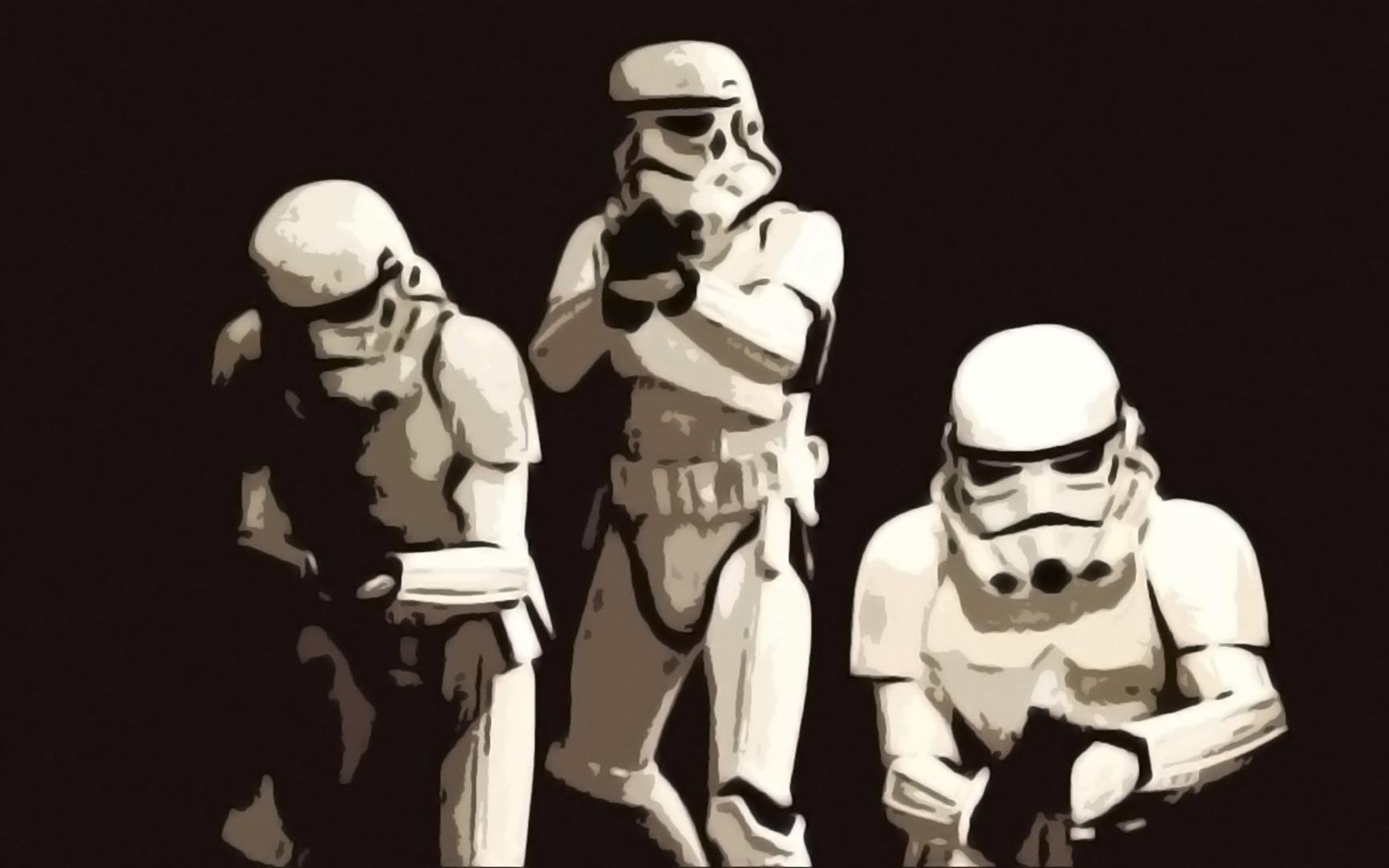 HD PC desktop wallpaper featuring three Star Wars stormtroopers poised in action against a dark background.