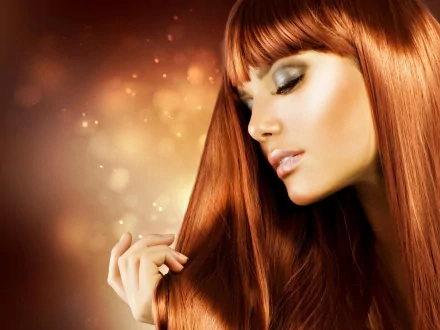 HD PC desktop wallpaper featuring a close-up portrait of a woman with long red hair and soft makeup, tagged Judy Wilkins, against a warm, glowing background.