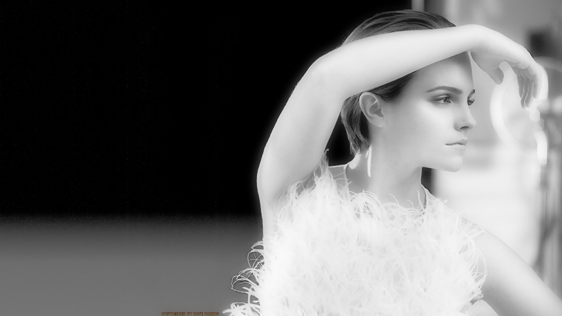 A high-definition wallpaper featuring Emma Watson in a striking pose, showcasing her elegance and beauty against a minimalist black background.