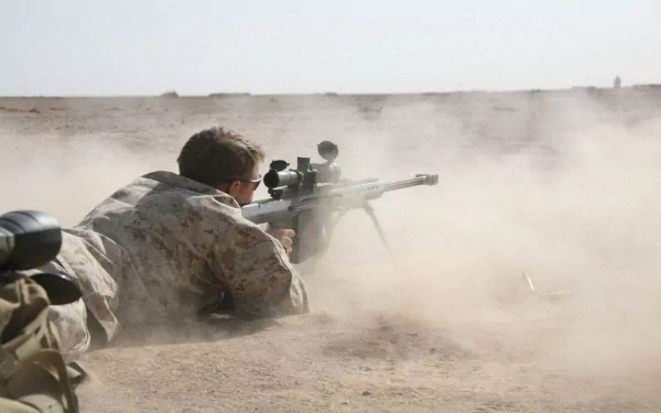 HD desktop wallpaper of a U.S. Army Infantry soldier in a desert setting aiming a sniper rifle, surrounded by dust in a military combat scene.