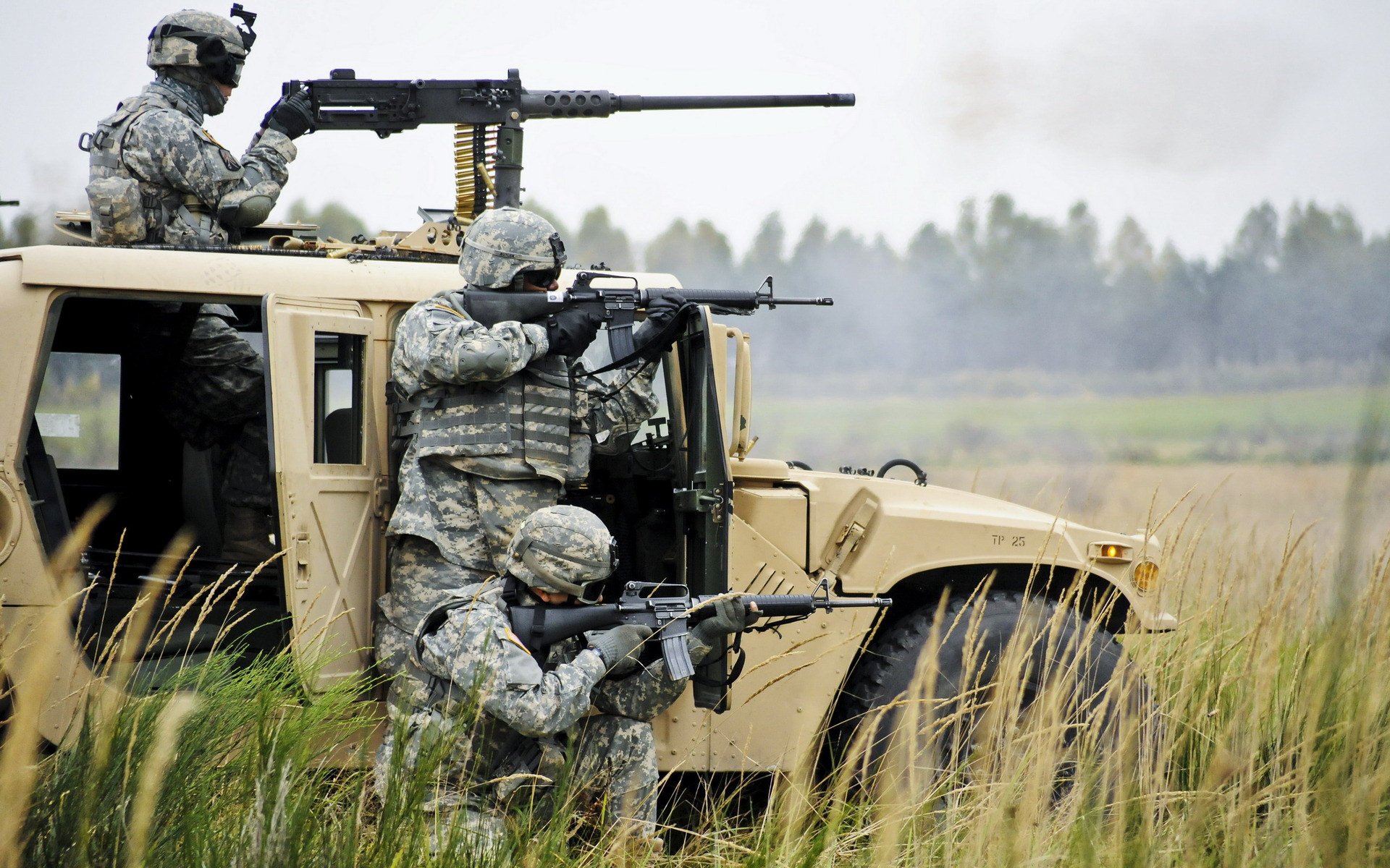 HD PC desktop wallpaper featuring soldiers in military gear positioned around a tactical vehicle in a grassy field, part of an active combat scene.