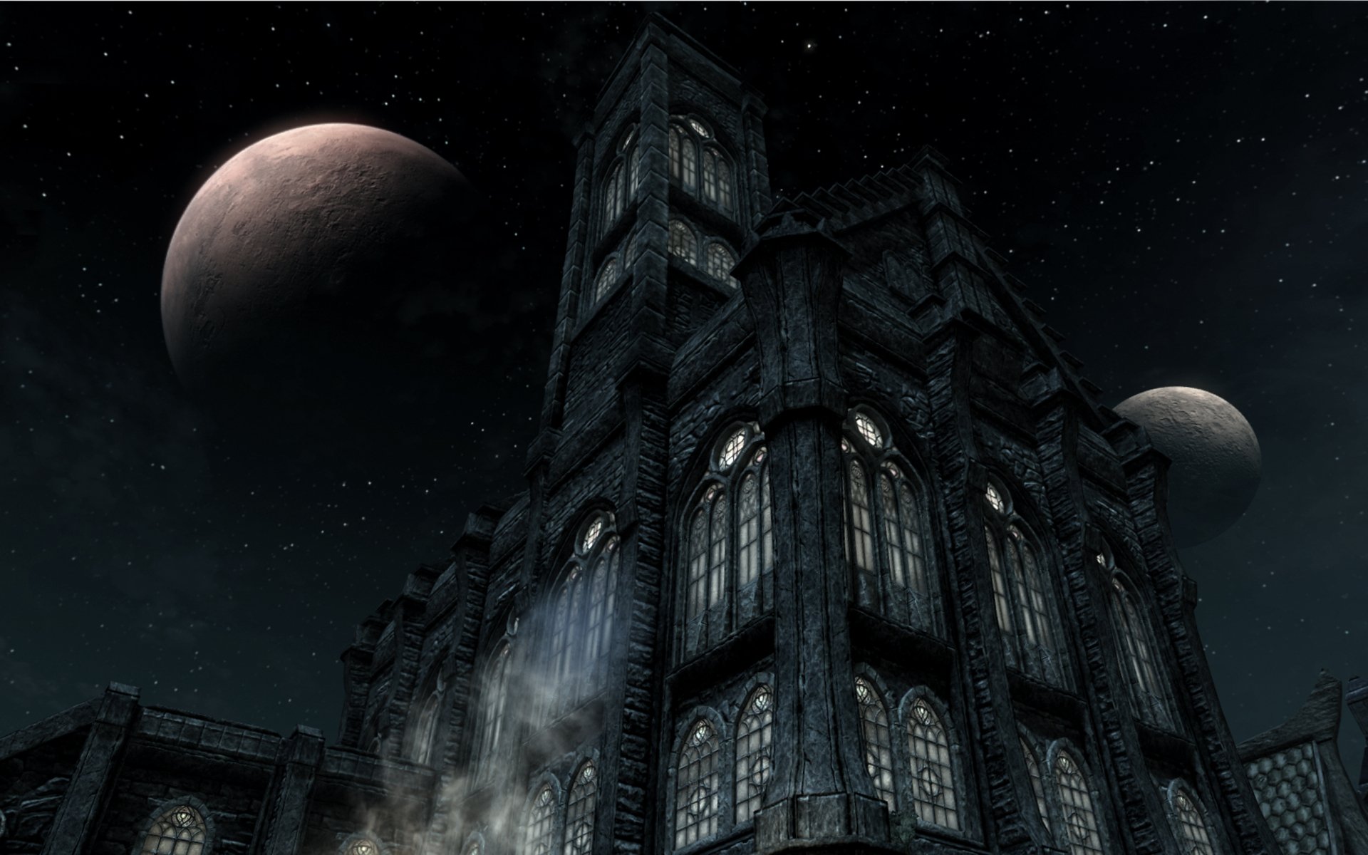 HD PC desktop wallpaper from The Elder Scrolls V: Skyrim showing a dark, towering castle under a starry sky with two moons in the background.