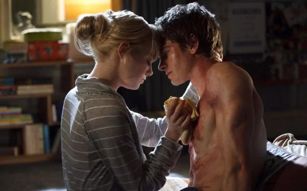 HD PC desktop wallpaper from the movie The Amazing Spider-Man: intimate bedside scene with a shirtless man and a woman in a striped sweater leaning foreheads together, warm bedside lighting.
