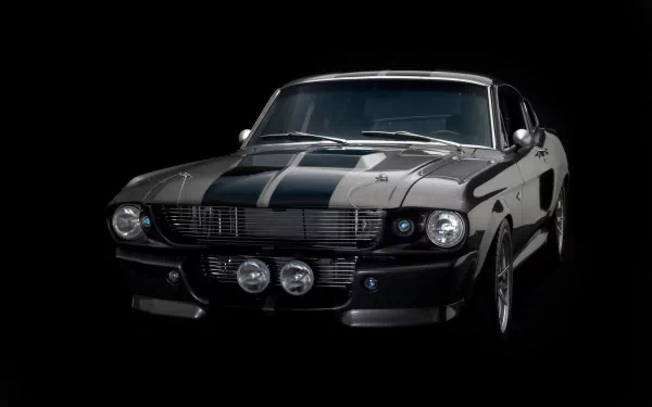 HD desktop wallpaper featuring a classic Ford Mustang Shelby GT500 in black with racing stripes, showcasing the iconic muscle car's bold design and powerful stance.