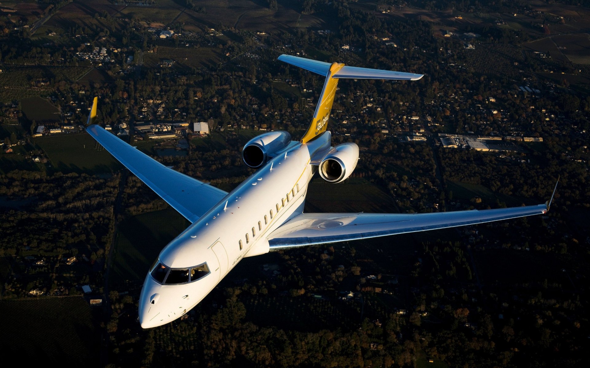 Bombardier Global 5000 vehicle, a business jet flying over a landscape, high-resolution 2K Quad HD PC desktop wallpaper and background.