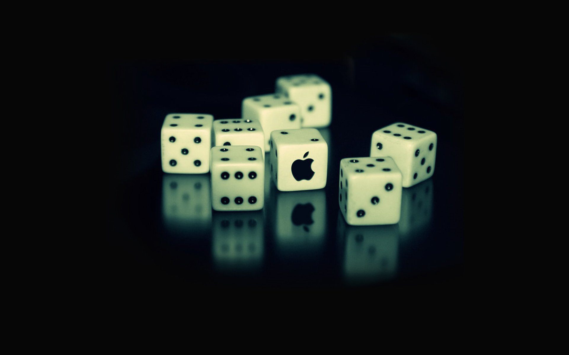 A stylish HD desktop wallpaper featuring white dice on a dark background, with one die showcasing the Apple Inc. logo, blending technology and creativity.