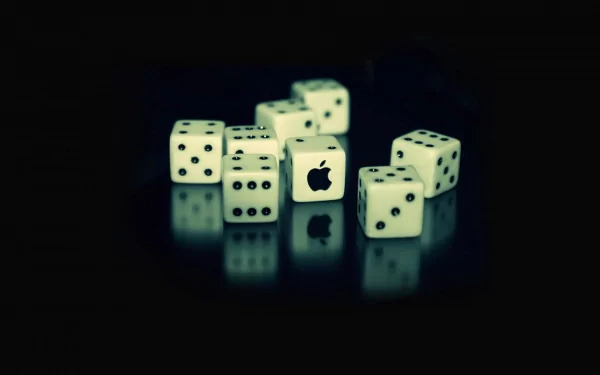 A stylish HD desktop wallpaper featuring white dice on a dark background, with one die showcasing the Apple Inc. logo, blending technology and creativity.