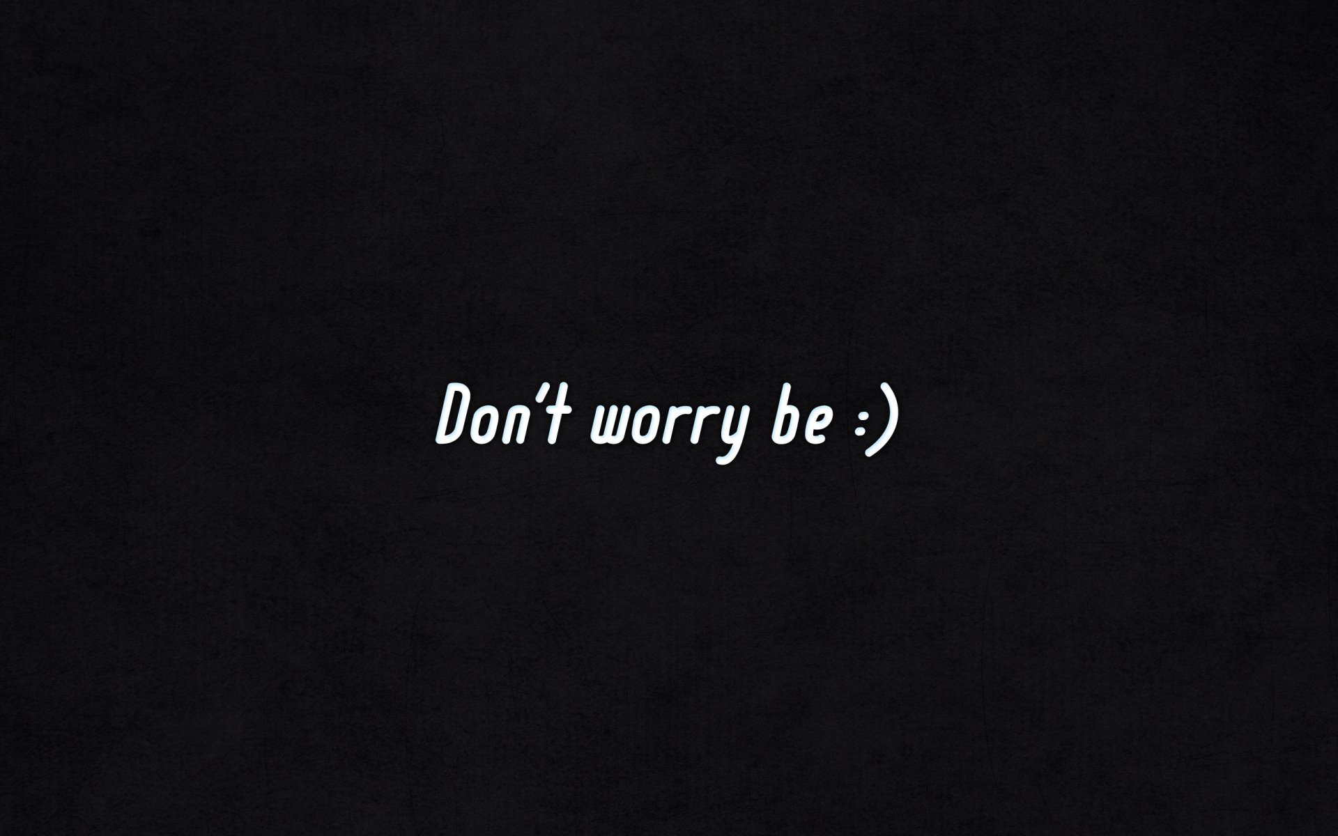 HD PC desktop wallpaper with a minimalist motivational message, Don't worry be :) on a black background, conveying calm and positivity.