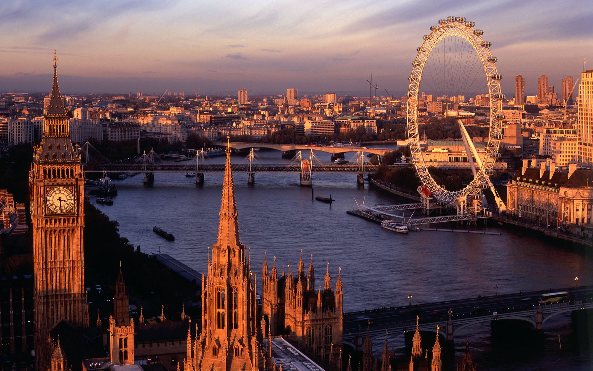 A 2K Quad HD PC desktop wallpaper of the London skyline at sunset featuring man-made landmarks Big Ben and the London Eye along the River Thames.