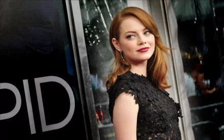 Emma Stone poses elegantly in a black lace dress against a sleek backdrop, showcasing her signature style in this HD desktop wallpaper and background.