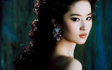 HD desktop wallpaper of an Asian woman, Liu Yifei, showcasing an elegant and oriental-inspired look, with a serene expression against a dark, textured background.
