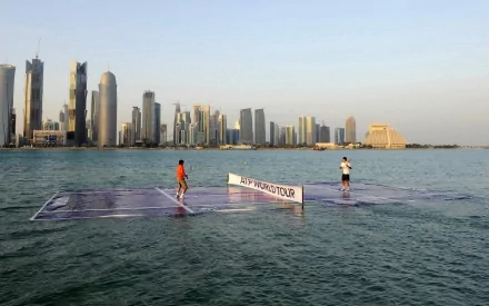 HD PC desktop wallpaper and background: tennis sports scene with two players on a floating court in calm water before a modern city skyline.