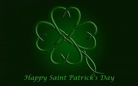 HD desktop wallpaper featuring a glowing green clover with Happy Saint Patrick's Day text, celebrating the St. Patrick's Day holiday.