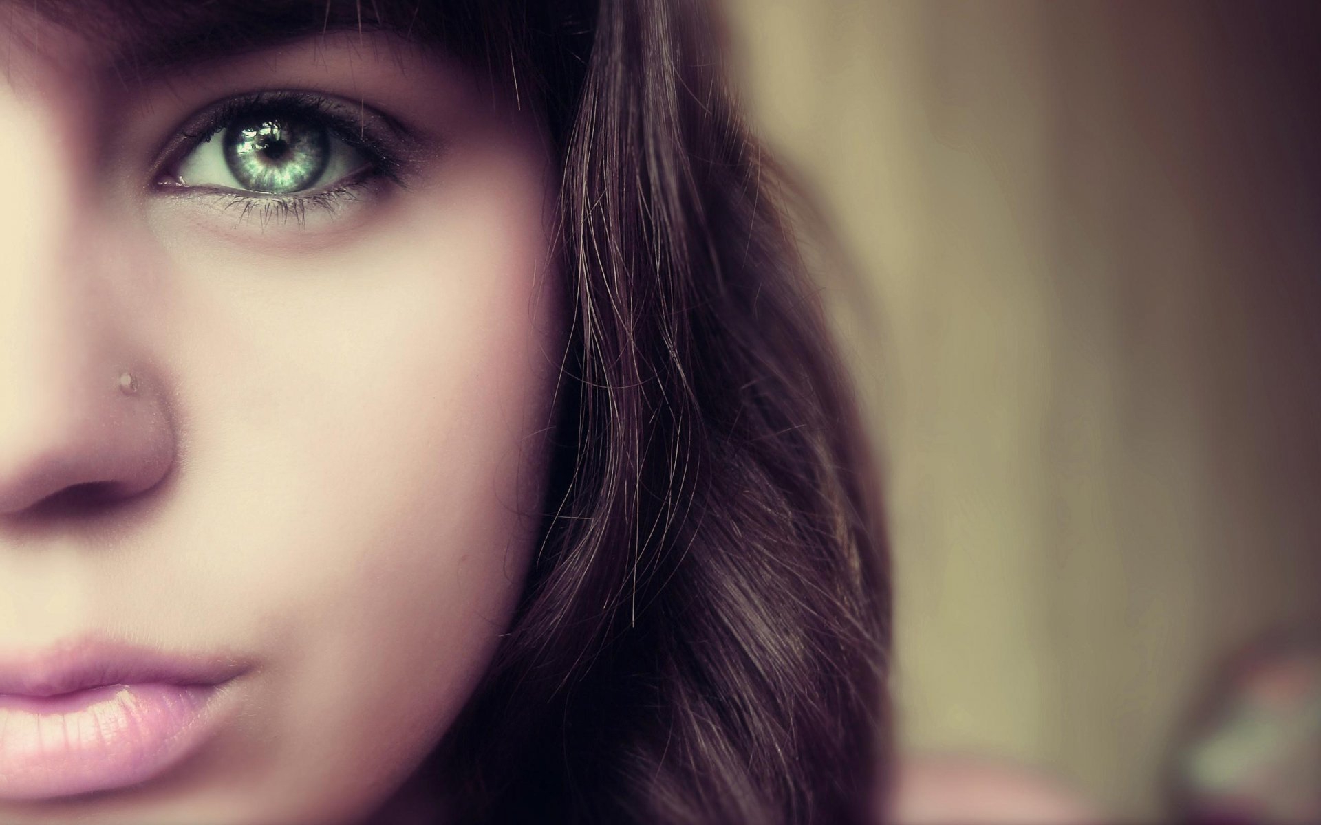 Close-up of a woman's face focusing on her striking green eye, captured in high definition for a PC desktop wallpaper background.