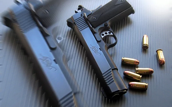 High-definition wallpaper featuring a Kimber pistol alongside several bullet casings, highlighting a sleek, modern design on a textured background.