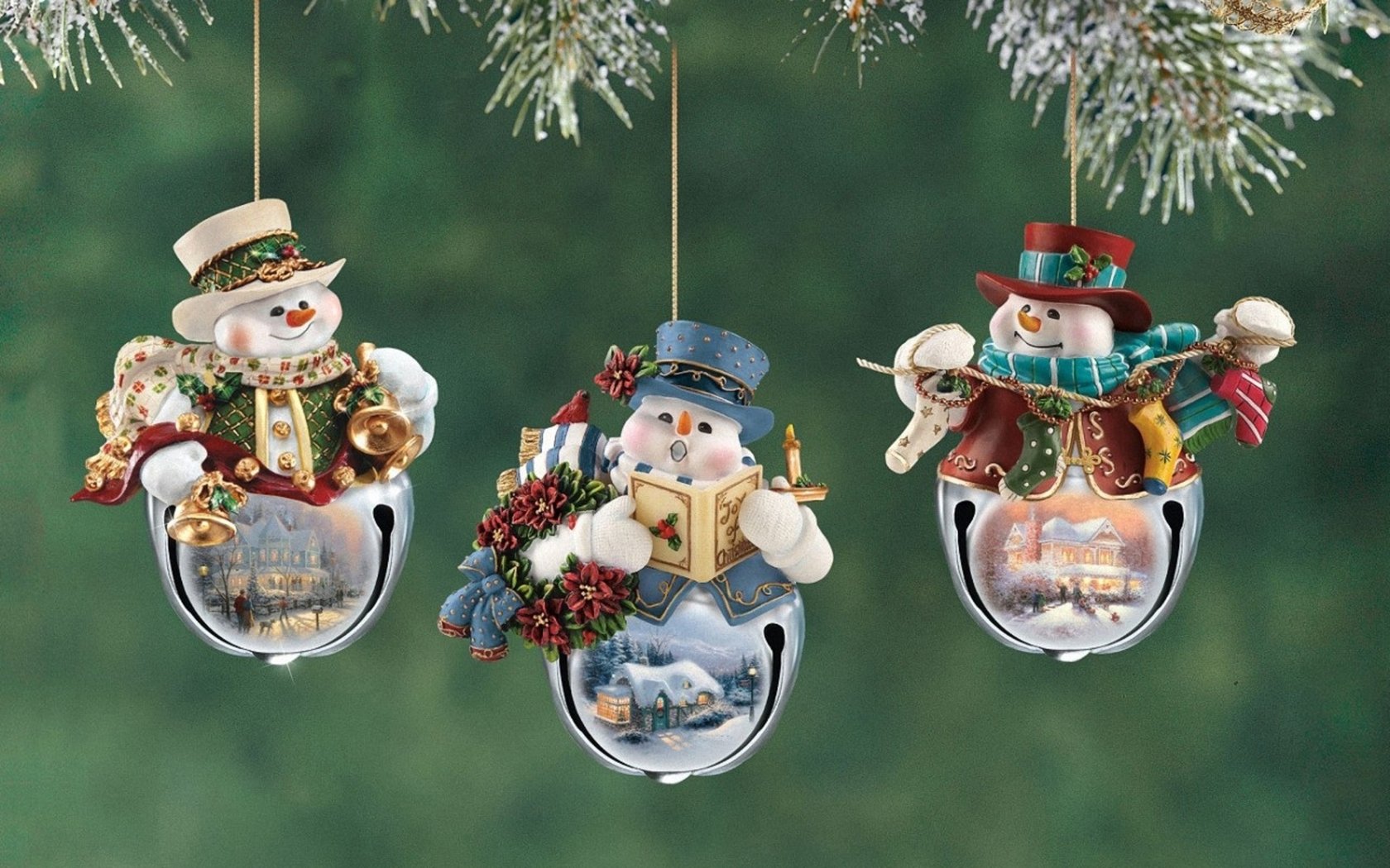 HD desktop wallpaper featuring three festive Christmas ornaments depicting snowmen on silver bells, set against a green holiday background.