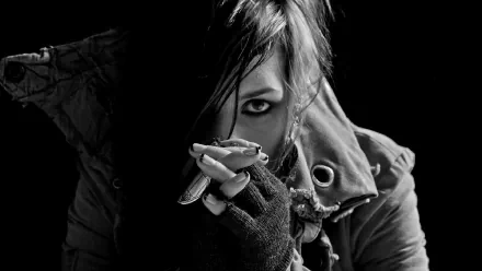 A striking black-and-white portrait of Noomi Rapace, showcasing her intense gaze and edgy style, set against a dark background, with artistic elements reminiscent of Skylar Grey's music.
