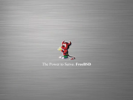A sleek HD wallpaper featuring the FreeBSD mascot and the text The Power to Serve: FreeBSD, set against a brushed metal background, celebrating FreeBSD and technology's intersection.