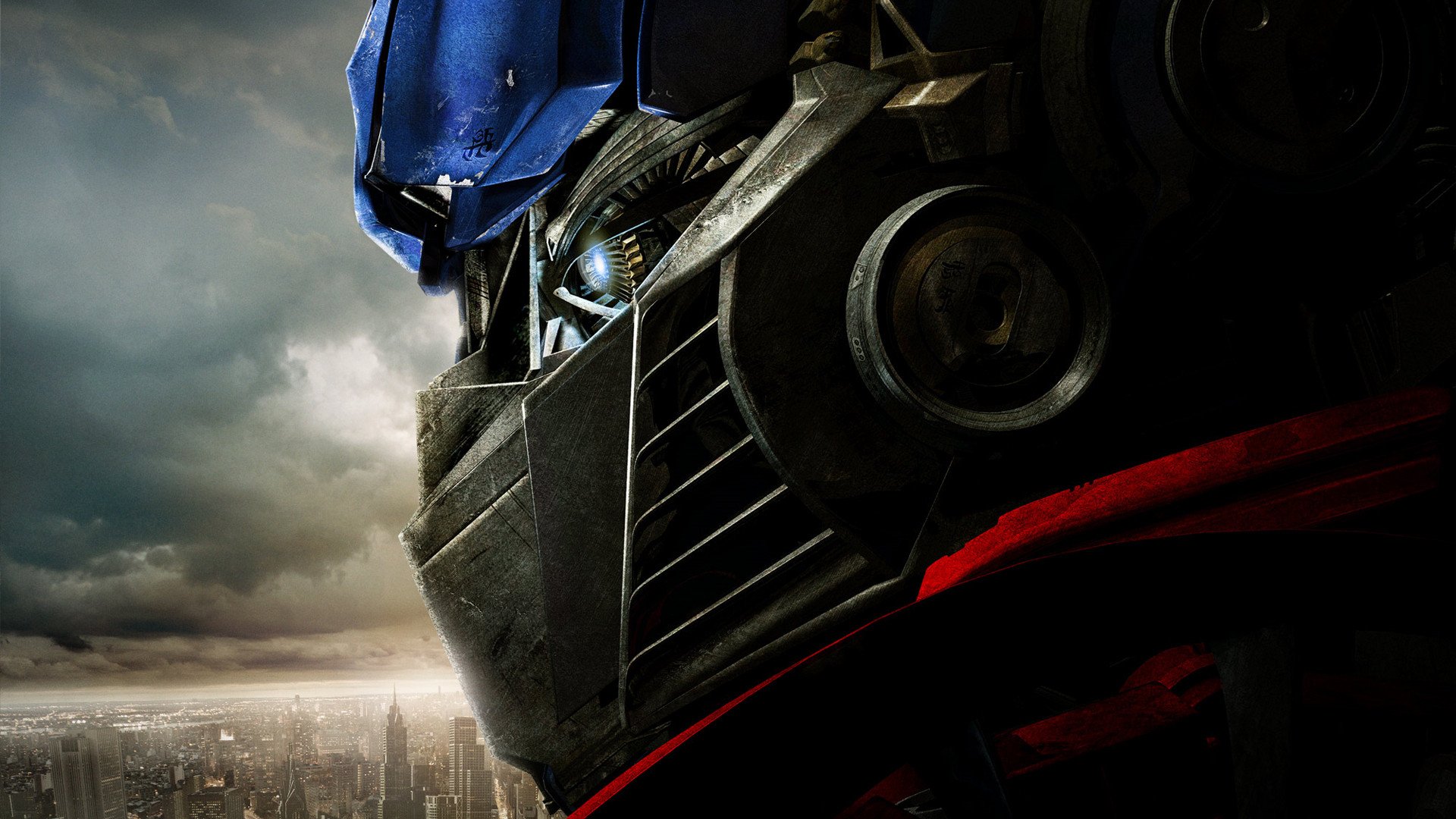 HD PC desktop wallpaper featuring a close-up of Optimus Prime from the Transformers movie against a cloudy cityscape background.