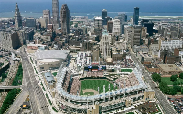 Aerial HD desktop wallpaper of Progressive Field in downtown Cleveland, Ohio, showing the man-made ballpark and surrounding city skyline along Lake Erie.