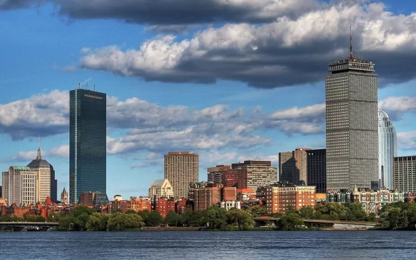 HD PC desktop wallpaper of Boston skyline across the Charles River featuring the Prudential Tower and other man-made buildings under a dramatic cloudy sky, Massachusetts.