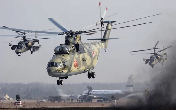 HD desktop wallpaper showing a military Mil Mi-26 helicopter in flight alongside other military helicopters over an airfield.