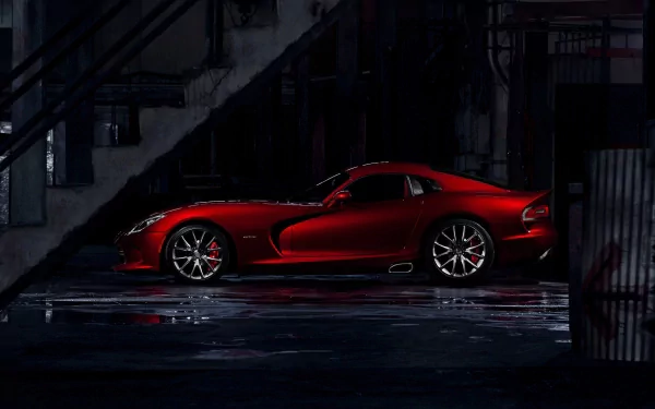 HD desktop wallpaper of a red Dodge SRT Viper GTS vehicle parked in a dark industrial garage, its sleek car profile reflected on a wet floor.